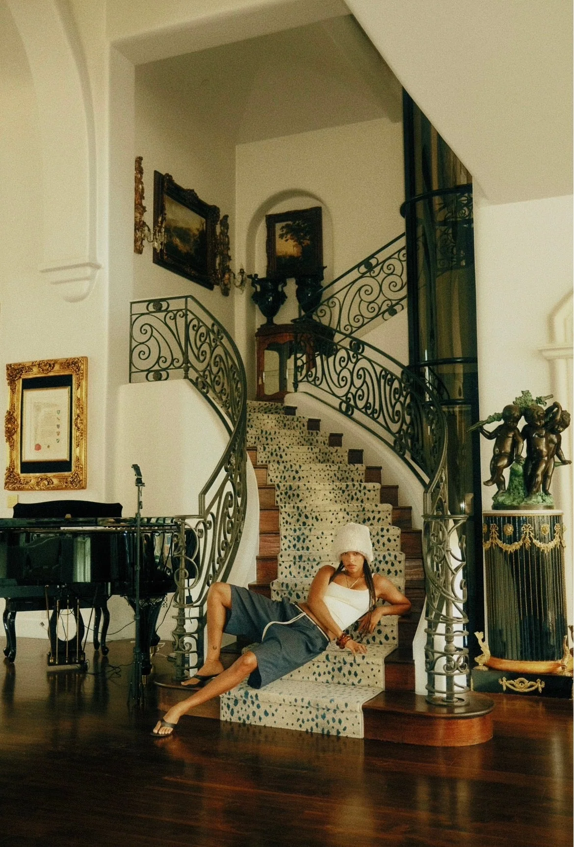 Wide Cannon Mitchel interior frame with a model on a staircase.