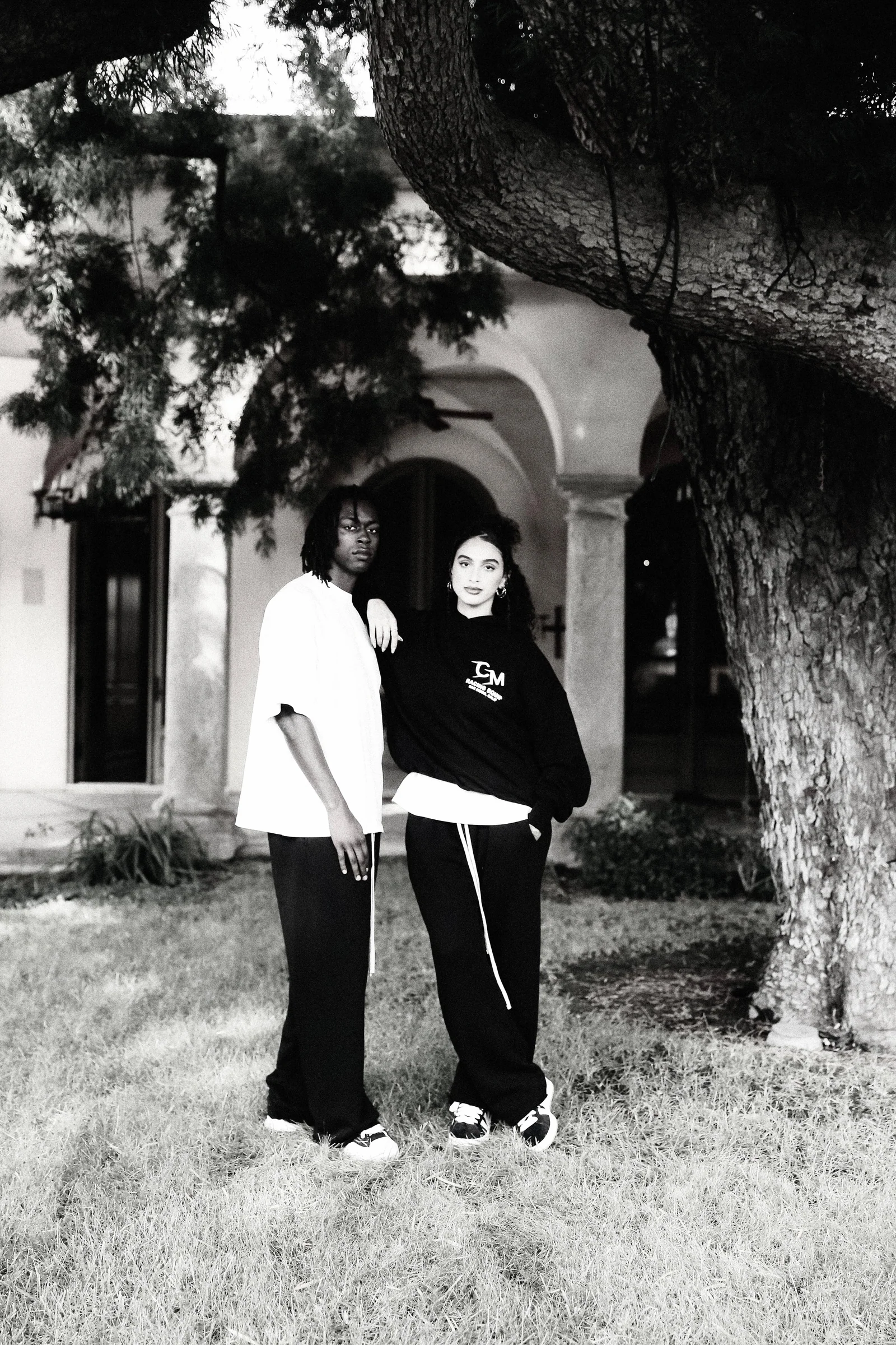 Black-and-white Cannon Mitchel exterior portrait with two models.