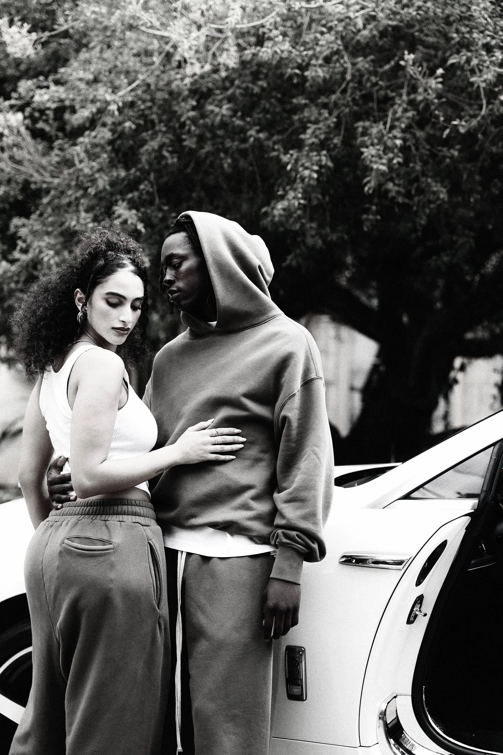 Black-and-white Cannon Mitchel car-side portrait with two models.