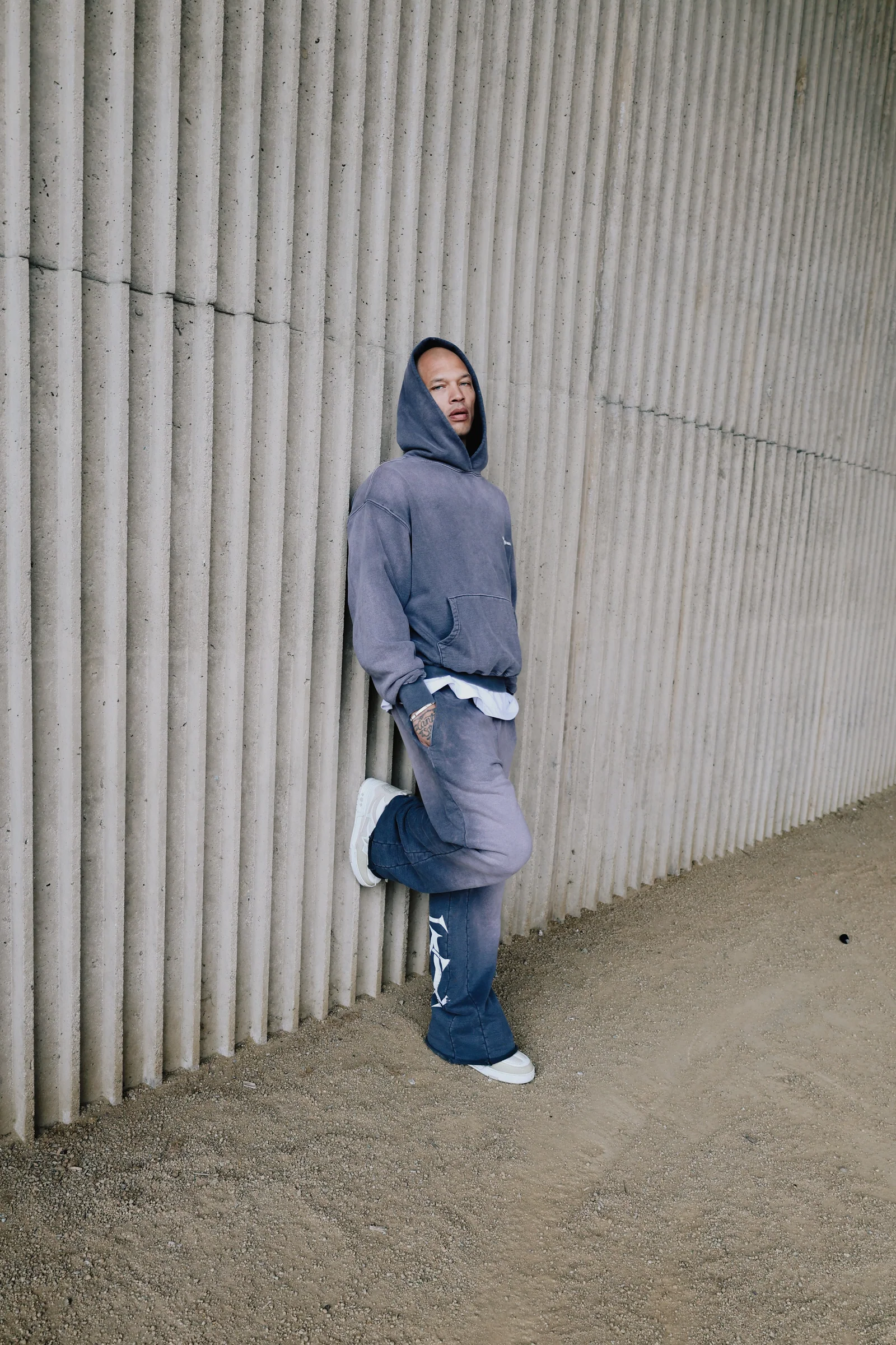 Parking structure portrait with a hooded Cannon Mitchel look.