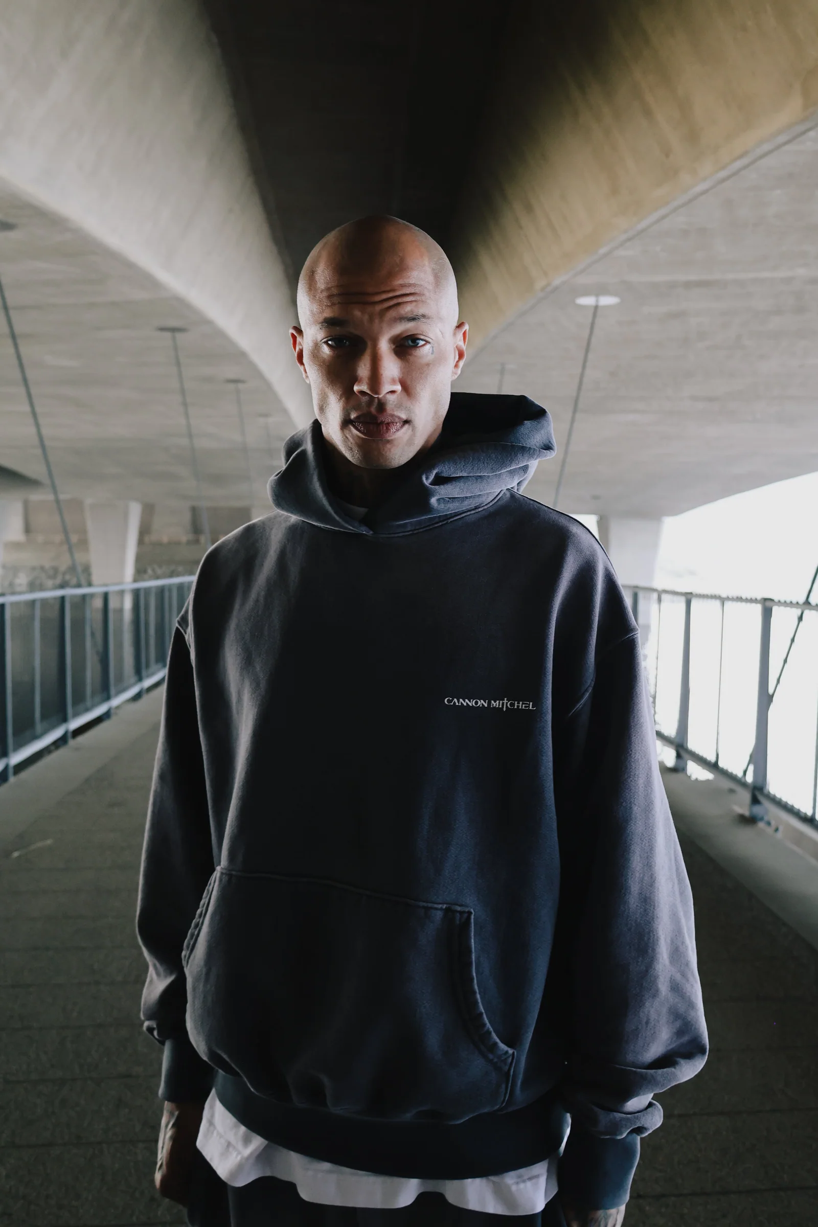 Color parking structure portrait in a dark Cannon Mitchel hoodie.