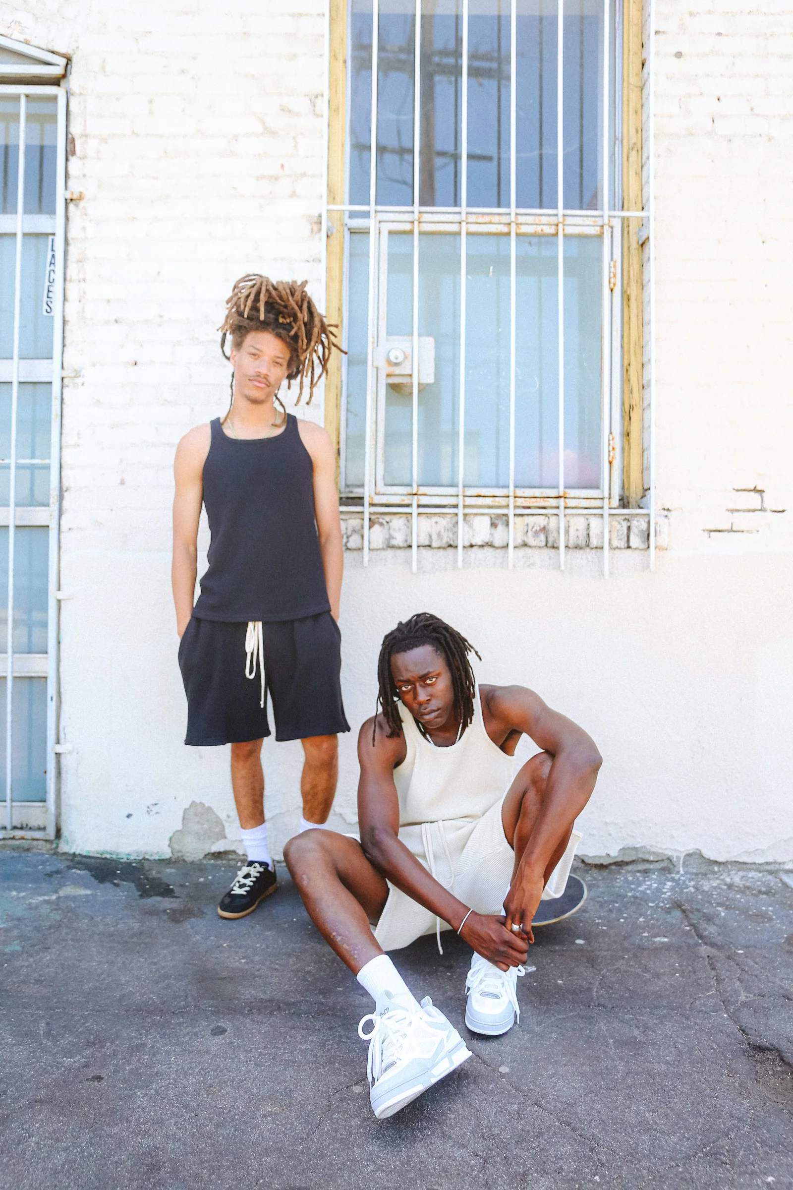 Two Cannon Mitchel models in a quiet exterior street portrait.