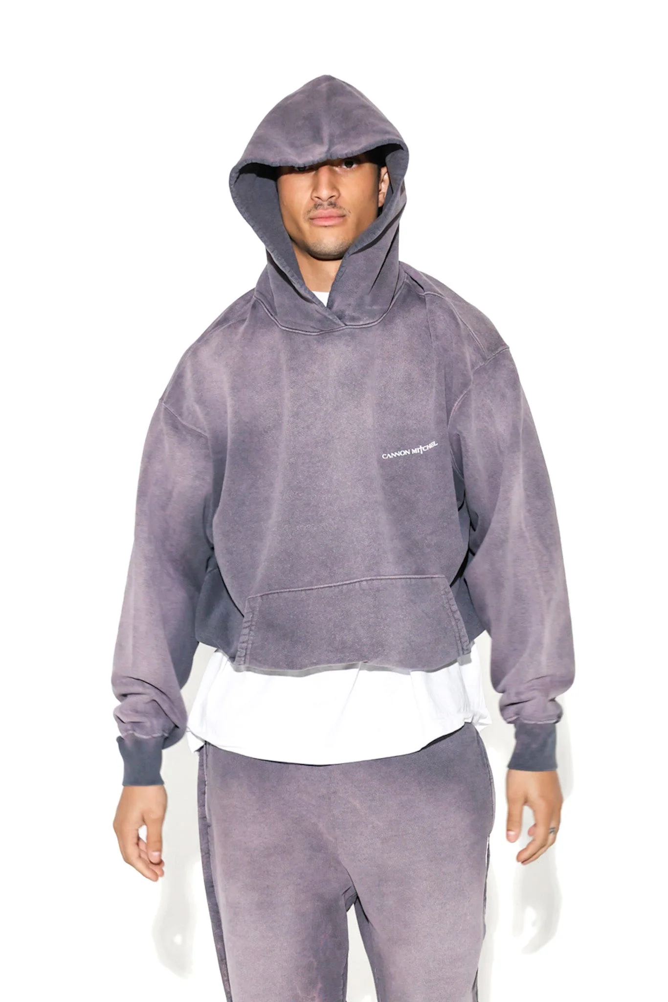 Studio portrait of a model in a washed gray Cannon Mitchel hooded set.
