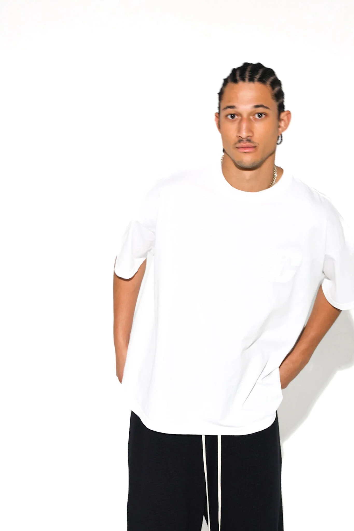 Close studio portrait of a model in a white Cannon Mitchel tee.