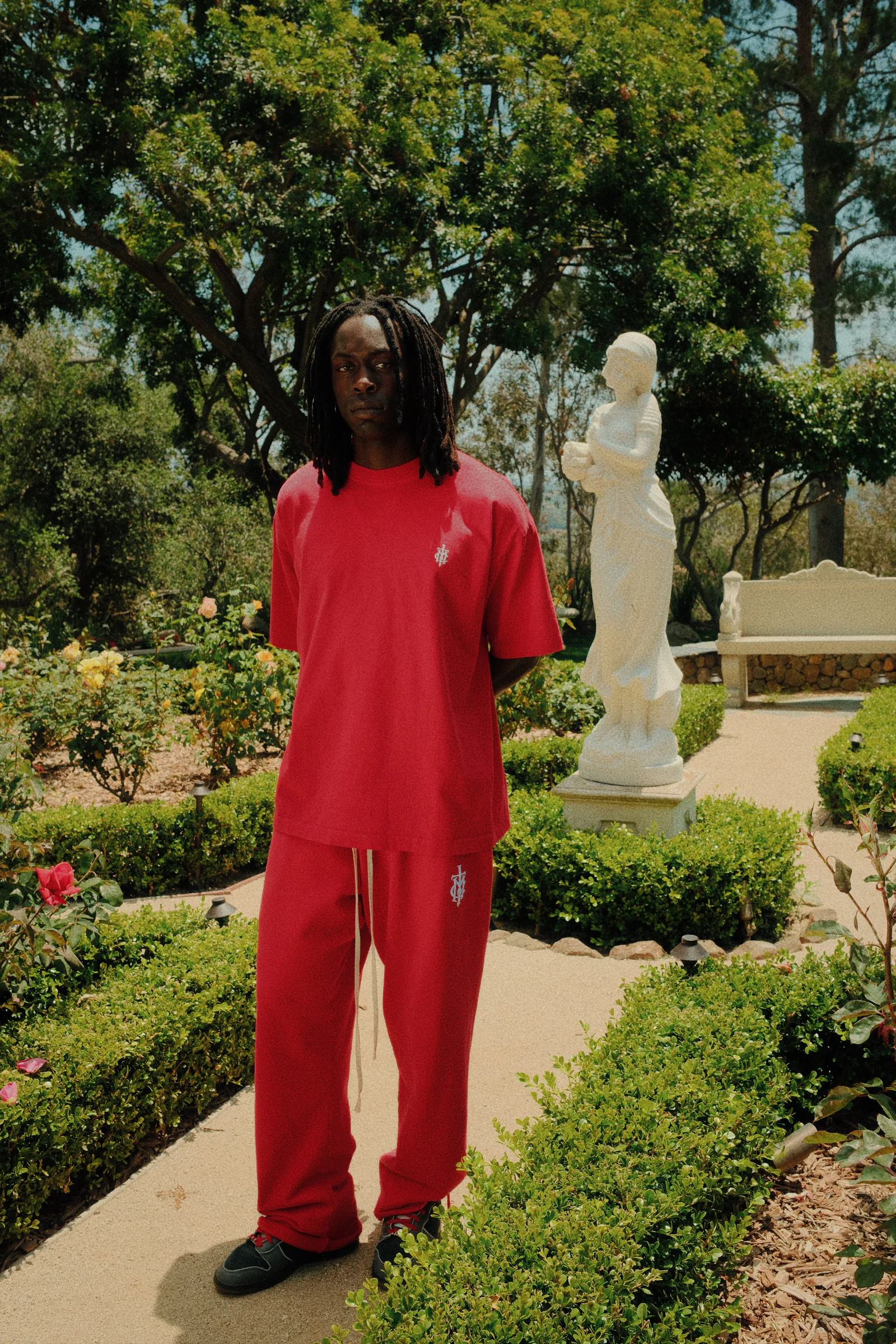Black Cannon Mitchel hoodie portrait against the garden landscape.