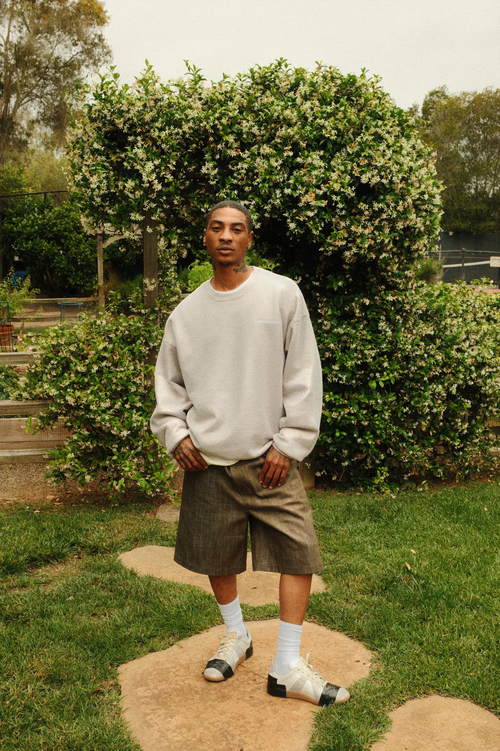 Cannon Mitchel carpenter shorts styled in the garden.