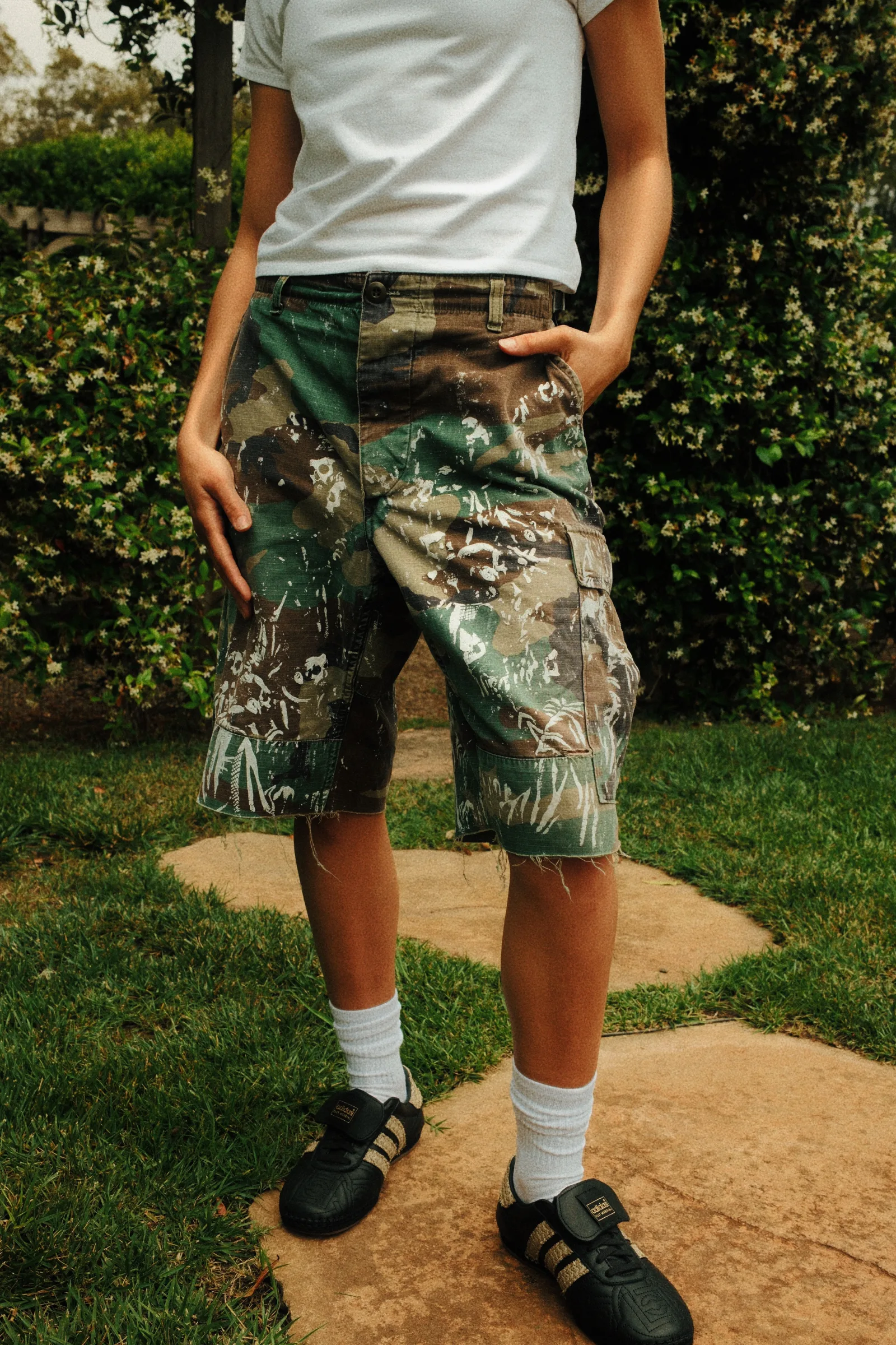 Close view of Cannon Mitchel printed shorts in the garden.