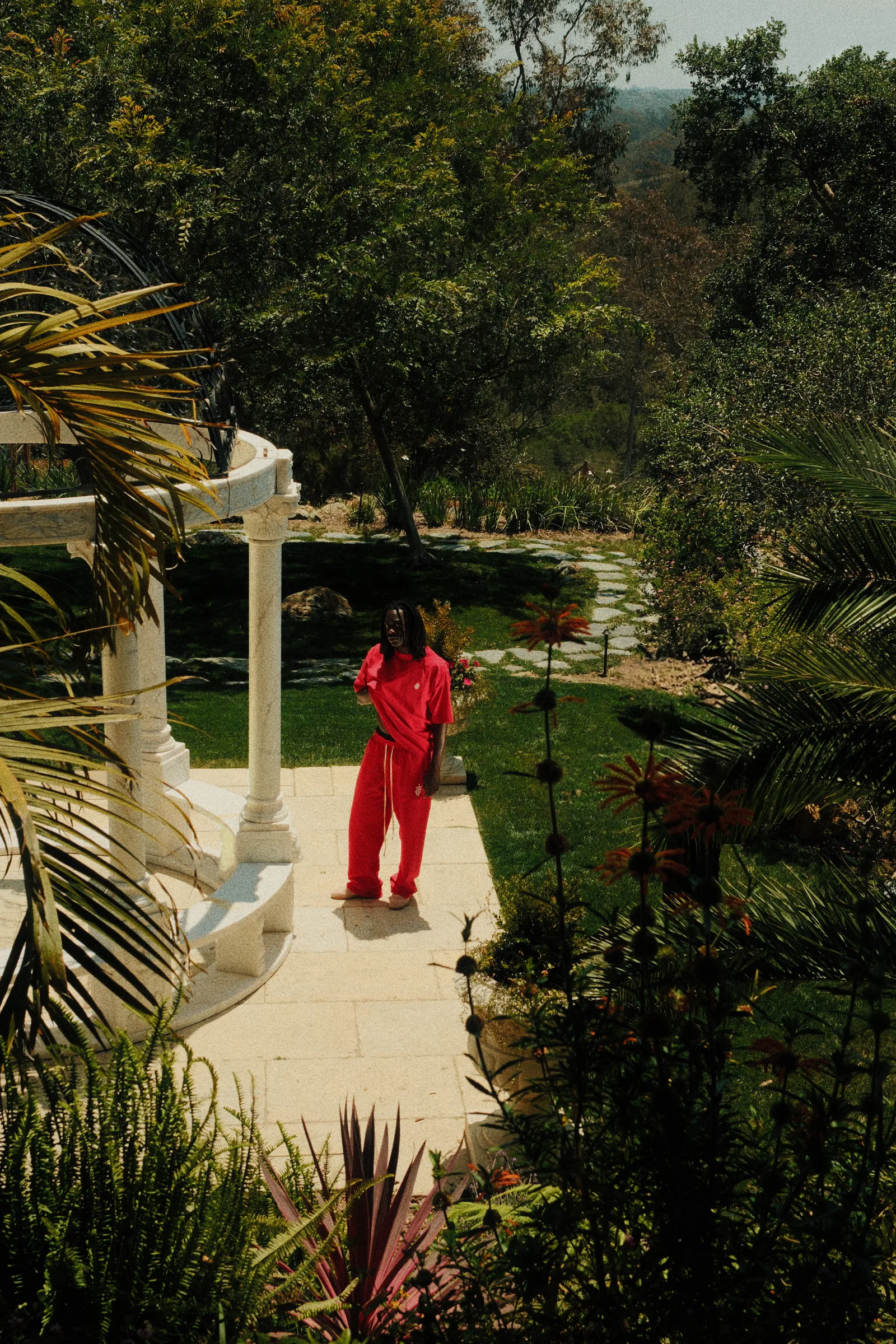 Cannon Mitchel red set framed across a formal garden.