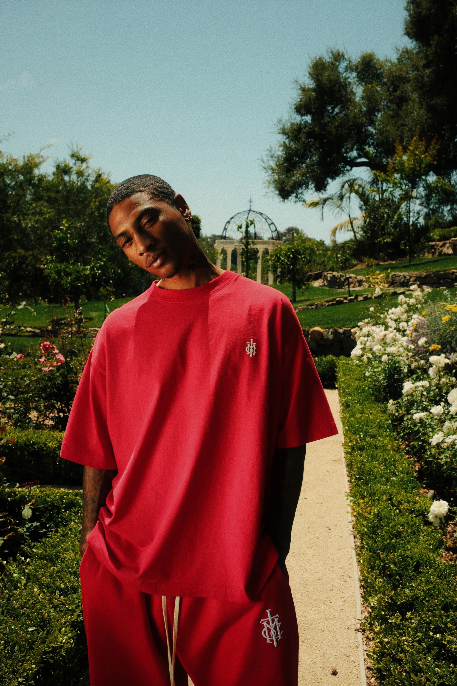 Cannon Mitchel red tee and matching pant photographed in the garden.