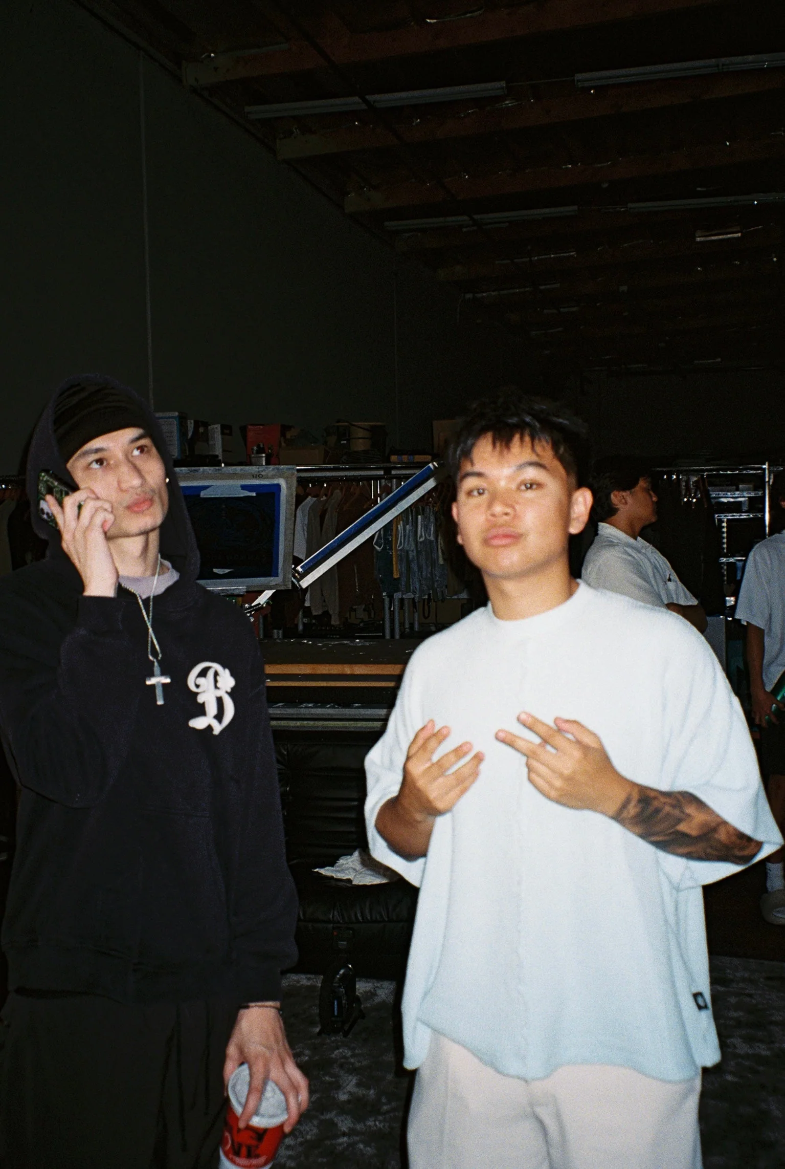 Behind-the-scenes SS26 studio moment with two people on set.